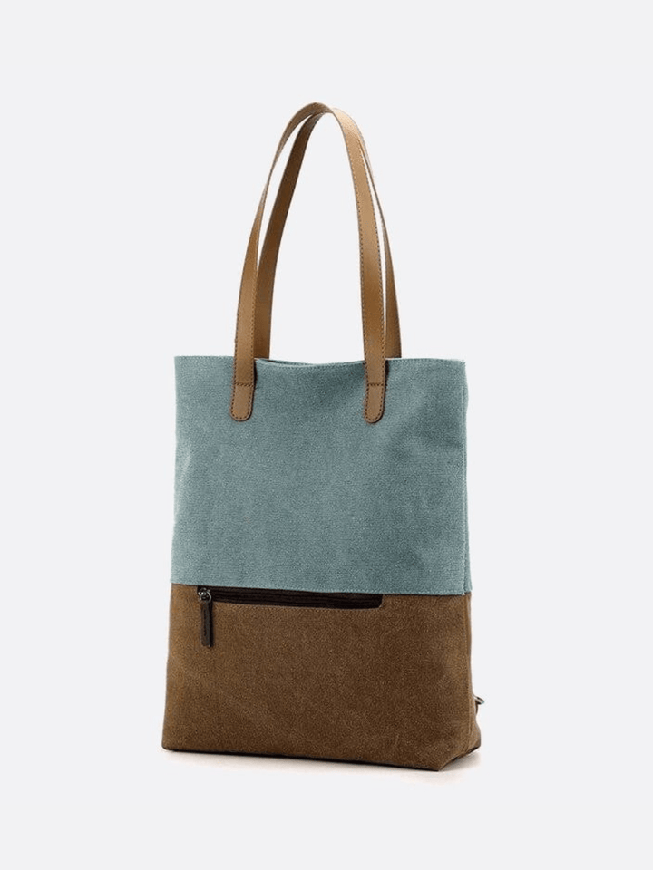 Sac turquoise toile porté épaule et dos